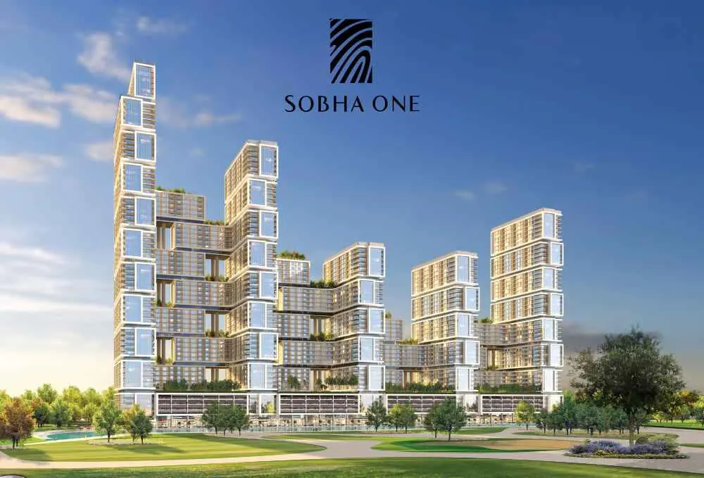 Tall modern towers of Sobha The Element at sunset with road and cars in foreground