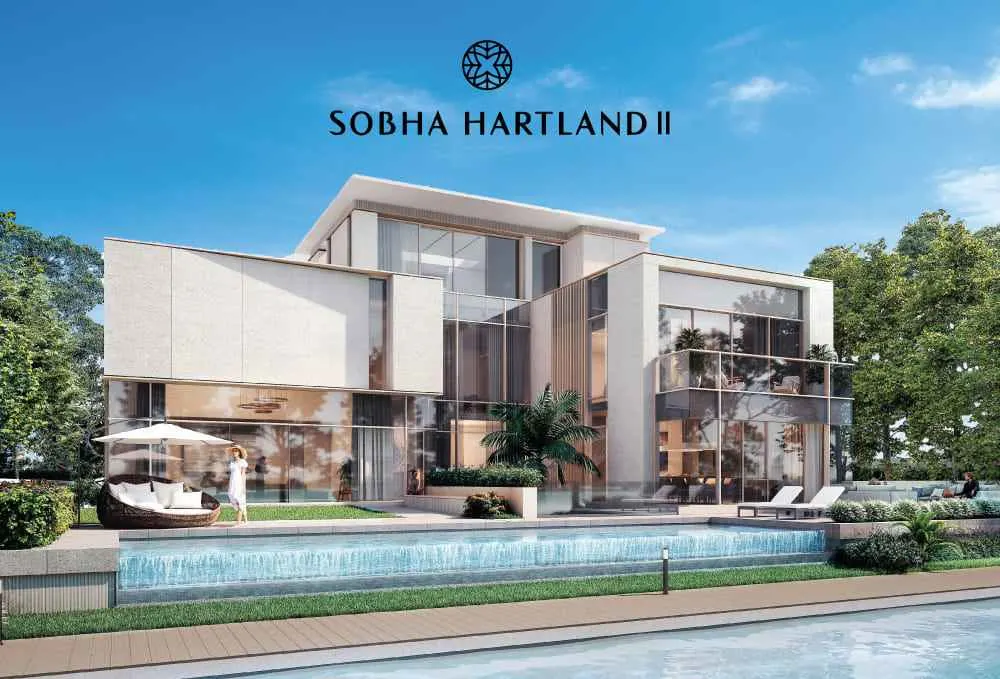 Tall modern towers of Sobha The Element at sunset with road and cars in foreground