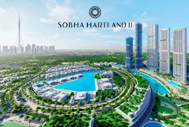 Tall modern towers of Sobha The Element at sunset with road and cars in foreground